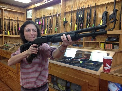 Mary Padian holds a rifle.
