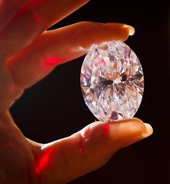 The Magnificent Oval Diamond egg size shaped jewel held in hand.