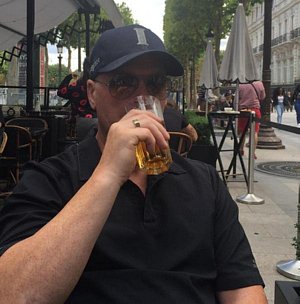 Roy drinks beer at an outside cafe in Paris, France.