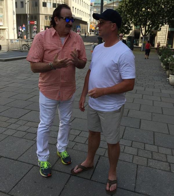 Mo Pigroff talks to Roy Dirnbeck on the streets of Vienna, Austria.