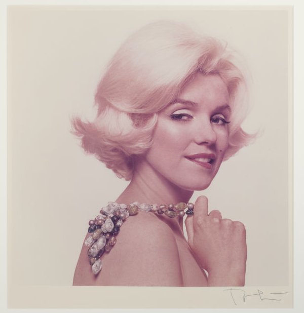 Marilyn Monroe Flirtatious holds necklace over shoulder semi nude