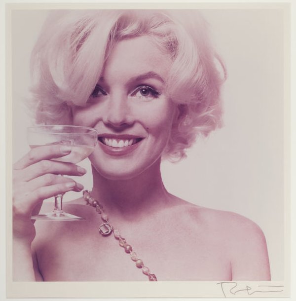 Marilyn Monroe semi-nude with drink in hand.