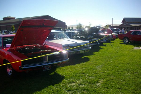 Row of classic cars at car show.