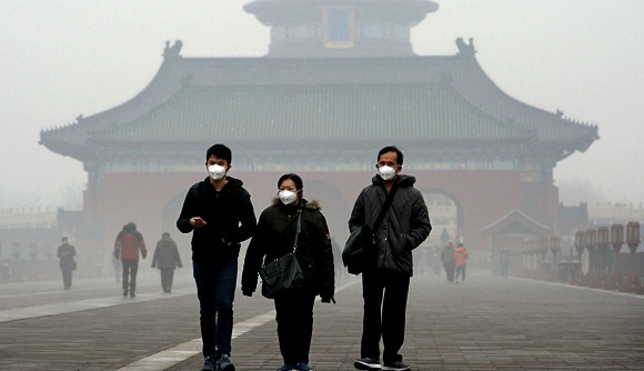 Three people walk with medical masks in Bejing.