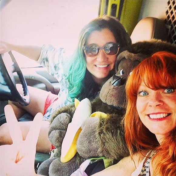 Candy Olsen and Courtney Wagner with stuff monkey inside their banana van.
