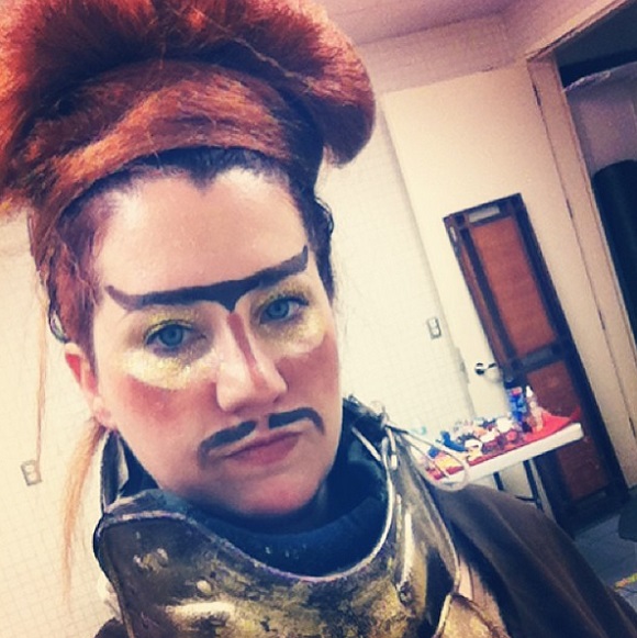 Courtney Wagner with red wig and warrior make-up.