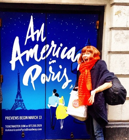 Candy Olsen stand in front of billboard sign An American in Paris.